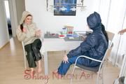 Jill and a friend of her enjoying a cup of coffee, smoking cigarettes at home while wearing supersexy blue and white rain- and downwear (Pics)