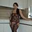 Chubby benita posing in a black bodystocking in the kitchen