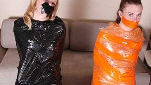 Sasha Swift & Christina Clark - Sasha Swift is captured, cuffed, gagged, and wrapped next to Christina Clark