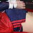 Sexy Sonja wearing a blue/red shiny nylon shorts and a blue/red rain jacket being tied and gagged with ropes on the ceiling(Pics)