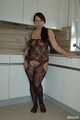 Chubby benita posing in a black bodystocking in the kitchen