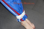 Mara tied and gagged on bed wearing s shiny blue PVC sauna suit (Pics)