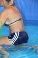 Watch Sandra cleaning the pool wearing a shiny nylon Shorts