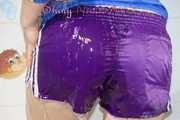 Sonja taking a shower wearing a very hot purple shiny nylon shorts and a blue rain jacket (Pics)