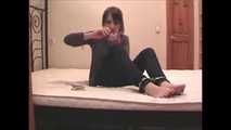 Satisfaction Girl - Barefoot brunette beauty uses cuffs and tape gag (video)