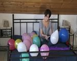 Smoking teen plays with many balloons