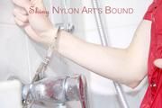 Sonja tied and gagged with cuffs and a cloth gag in a shower wearing a sexy red shiny nylon jumpsuit (Pics)