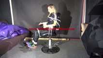 Sexy Sandra being tied and gagged on a hairdresser`s chair with ropes and a ballgag wearing a sexy black shiny nylon jumpsuit (Video)