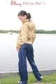 Enni posing outdoor on a lake wearing a supersexy blue shiny nylon rain pants and a golden rain jacket (Pics)