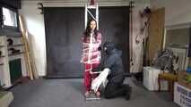 Ayana in a shiny nylon red rainsuit and a see through PVC Rainjacket, tied gagged, hooded and vibed