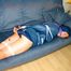 Katharina tied, gagged and hooded on a blue sofa wearing a sexy shiny nylon shorts and a rain jacket in blue (Pics)