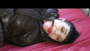 03:10 Min. video with Jill bound and gagged in a shiny nylon down coat