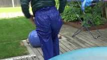 Watching sexy Sandra wearing a sexy blue rainsuit and a green downjacket enjoying the sun and the water in the pool (Video)