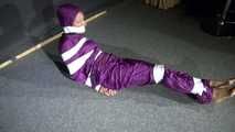Sexy Sandra wearing a supersexy purple shiny nylon rainsuit bein tied and gagged and hooded on the floor with tape (Video)