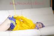 SEXY MARA being tied and gagged on the ceiling with ropes wearing a hot blue shiny nylon shorts and a yellow rain jacket (Pics)