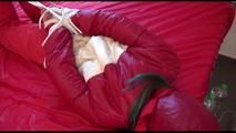 Mara tied, gagged and hooded on bed wearing a shiny red old school down jacket and pants (Video)