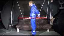 SUPERSEXY SANDRA wearing sexy shiny blue rainwear being tied and gagged overhead with ropes and a bar treated with a massager (Video)