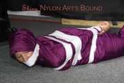 Sexy Sandra being tied, gagged and hooded with tape on the floor wearing a supersexy purple rain overall (Pics)