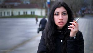 A big-eyed girl is smoking 100s cork Marlboro Red