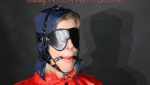 Watching Pia wearing a supersexy shiny nylon rainwear sitting on a hairdresser´s chair being tied and gagged with ropes, eye patches and a ballgag  (Pics)