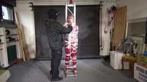 Ayana in a shiny nylon red rainsuit and a see through PVC Rainjacket, tied gagged, hooded and vibed