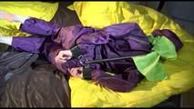 Lucy tied, gagged and hooded on bed on a bar wearing sexy purple rainwear (Video)