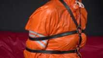 Sexy Pia wearing an oldschool orange shiny nylon rain pants and rain jacket being tied and gagged with belts and a ballgag on a chair (Video)