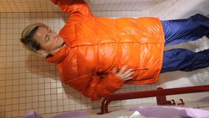 SEXY SONJA wearing a black shiny nylon rain pants and an orange big downjacket enjoying a bath (Pics)