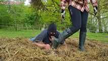 Rubber boot mistress presses slave face into manure