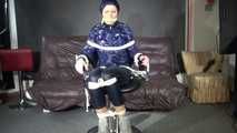 See Ronja tied and gagged on a Barber Chair in shiny nylon Rainwear and a shiny cape!