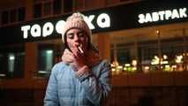 Lovely Russian girl Karina smokes a cigarette in the cold outside 