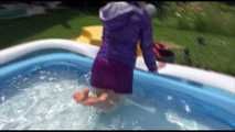 Watching Mara wearing a sexy short down skirt and a down jacket playing with water in the swimming pool (Video)
