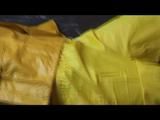 Pia tied and gagged in an yellow rainsuit on bed (Video)
