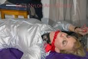Pia ties and gagged on a bed with cuffs and chains wearing a sexy shiny nylon shorts and a rain jacket (Pics)