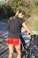 Watch Sandra riding her bike enjoying her red shiny nylon Shorts