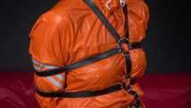 Sexy Pia wearing an oldschool orange shiny nylon rain pants and rain jacket being tied and gagged with belts and a ballgag on a chair (Video)