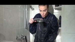 Jill wearing a sexy red shiny nylon shorts and a black rain jacket while taking a shower and play with babyoil (Video)