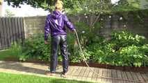 Watching sexy Sandra wearing a sexy blue rain pants and a purple rain jacket watering the flowers in the garden (Video)