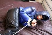 Jill hooded, bound and gagged in sexy shiny black rainwear and blue down jacket 