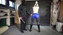 Lady M tied and spanked in shiny blue nylon shorts wearing latex Pants under the Shorts