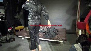 Watching sexy Pia wearing a sexy black shiny nylon jumpsuit reordering rainwear (Video)