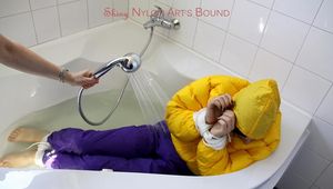 Julia tied and gagged in a ski suit in the bath tub