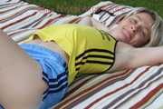 Sexy Sonja wearing a lightblue shiny nylon shorts with a yellow top durig her bath in the sun (Pics)