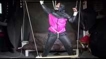 Mara tied, gagged and hooded overhead with ropes and a clothgag wearing a sexy rainwear combination (Video)