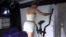 Watching sexy Sandra wearing a sexy shiny nylon shorts and a adidas top during her stretching and workout on the crosstrainer (Video)