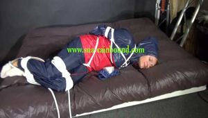 Watch Sandra hogtied and pantygagged in her shiny nylon Rainwear trying to free herself.