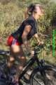 Watch Sandra riding her bike enjoying her red shiny nylon Shorts