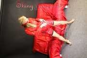 Watching sexy Sandra during her selfbondage action with cuffs in a red shiny nylon Crazy Sensations Chillshorty and a shiny nylon rain jacket in red (www.crazysensations.com). Buy the original Short (used) from us.