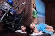 Lucky, Nelly, Xenia - All hogtied, Lucky posed on motorbike while tied up