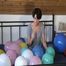 Smoking teen plays with many balloons